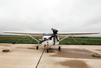 man riding white plane during daytime