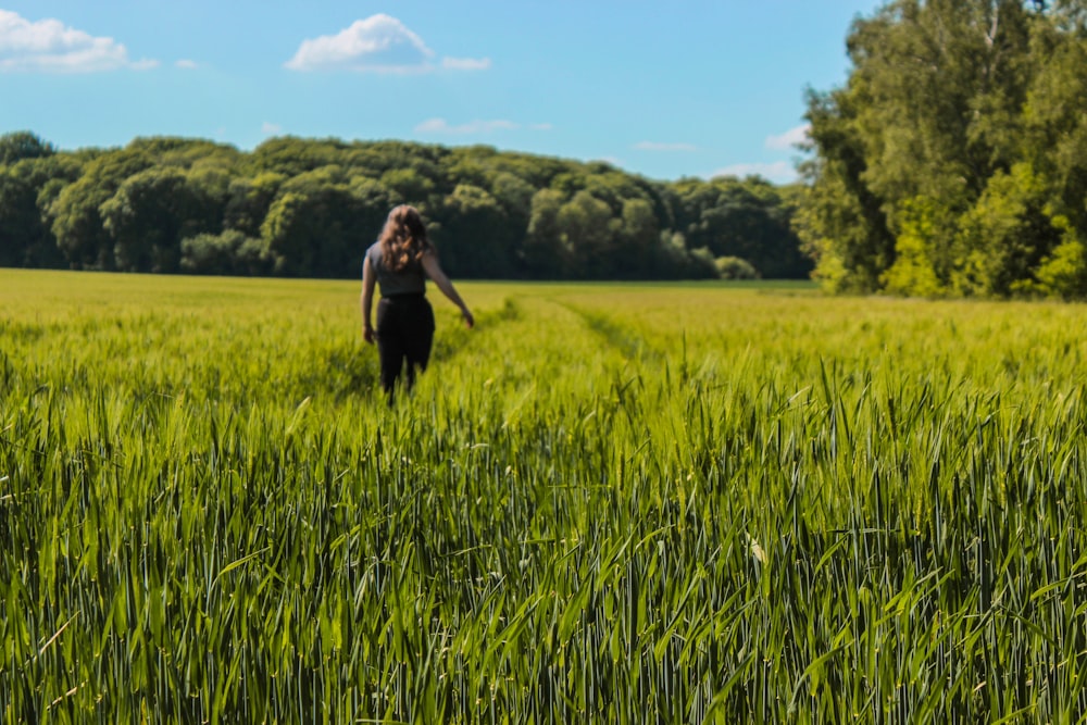 person standing on grass field