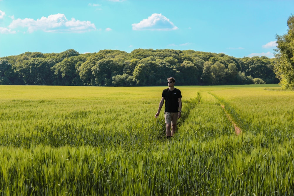 man walking on grass field