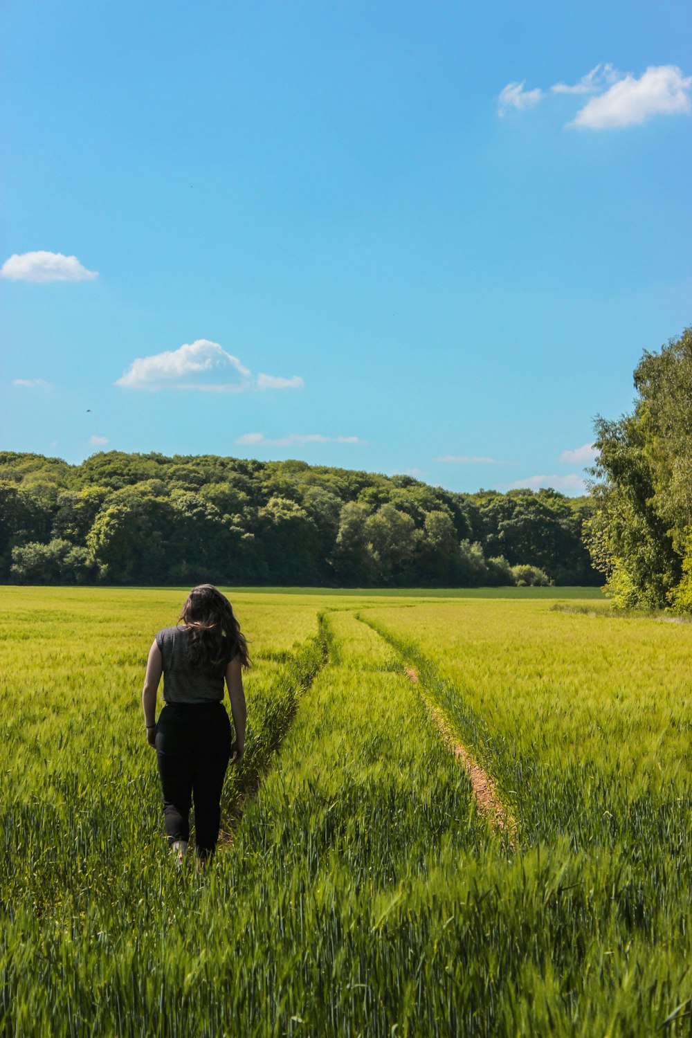 woman walks on grass field