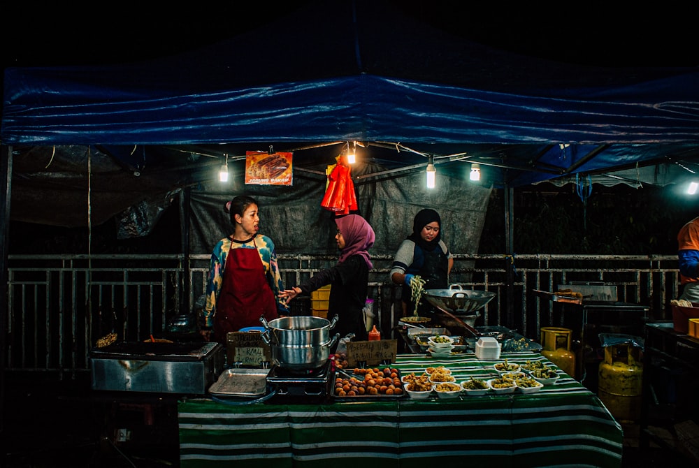 group of people standing inside booth