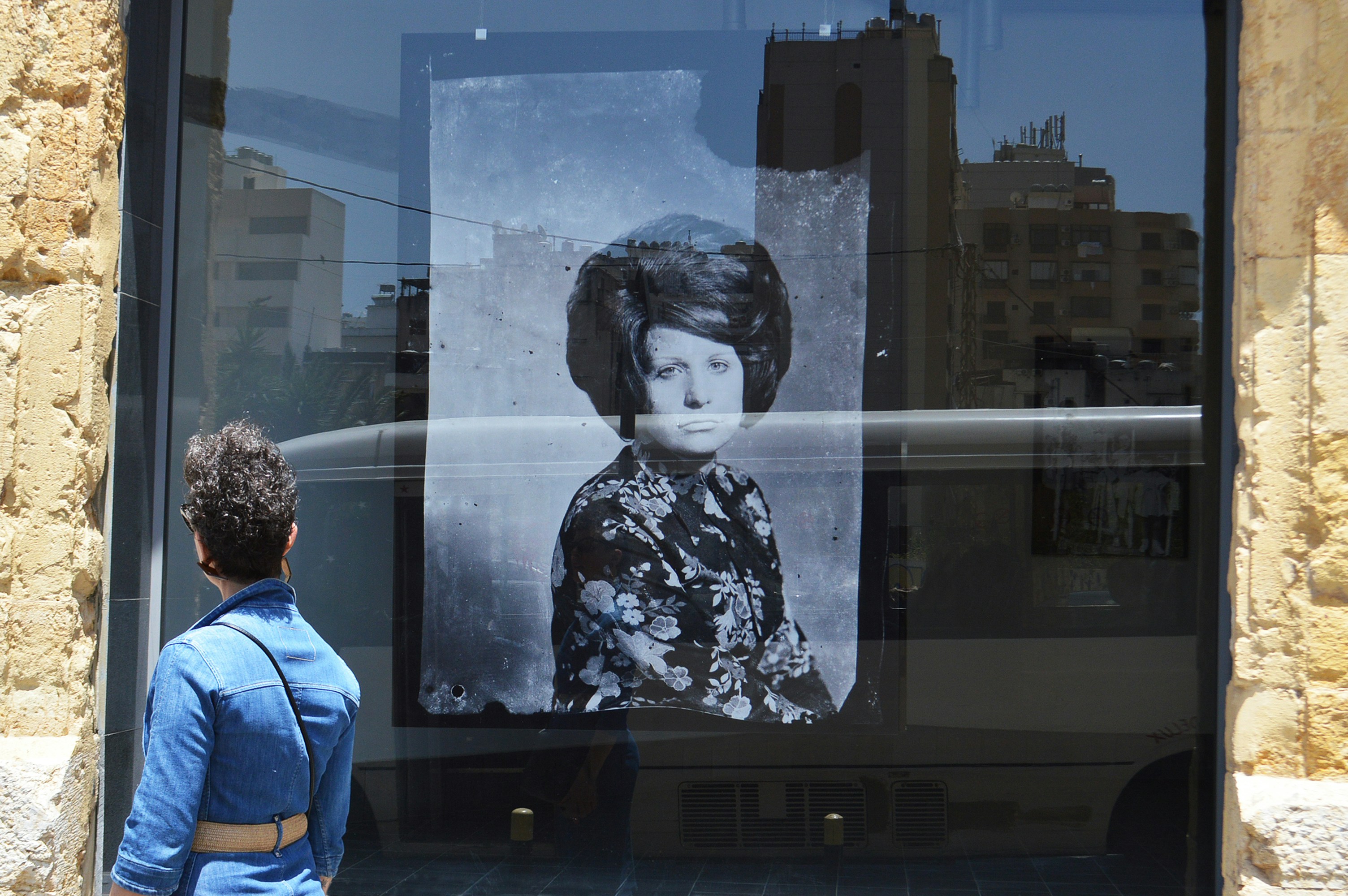 person in blue jacket standing outside building