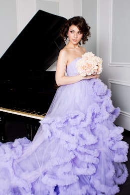 woman in purple off-shoulder dress holding bouquet of flowers