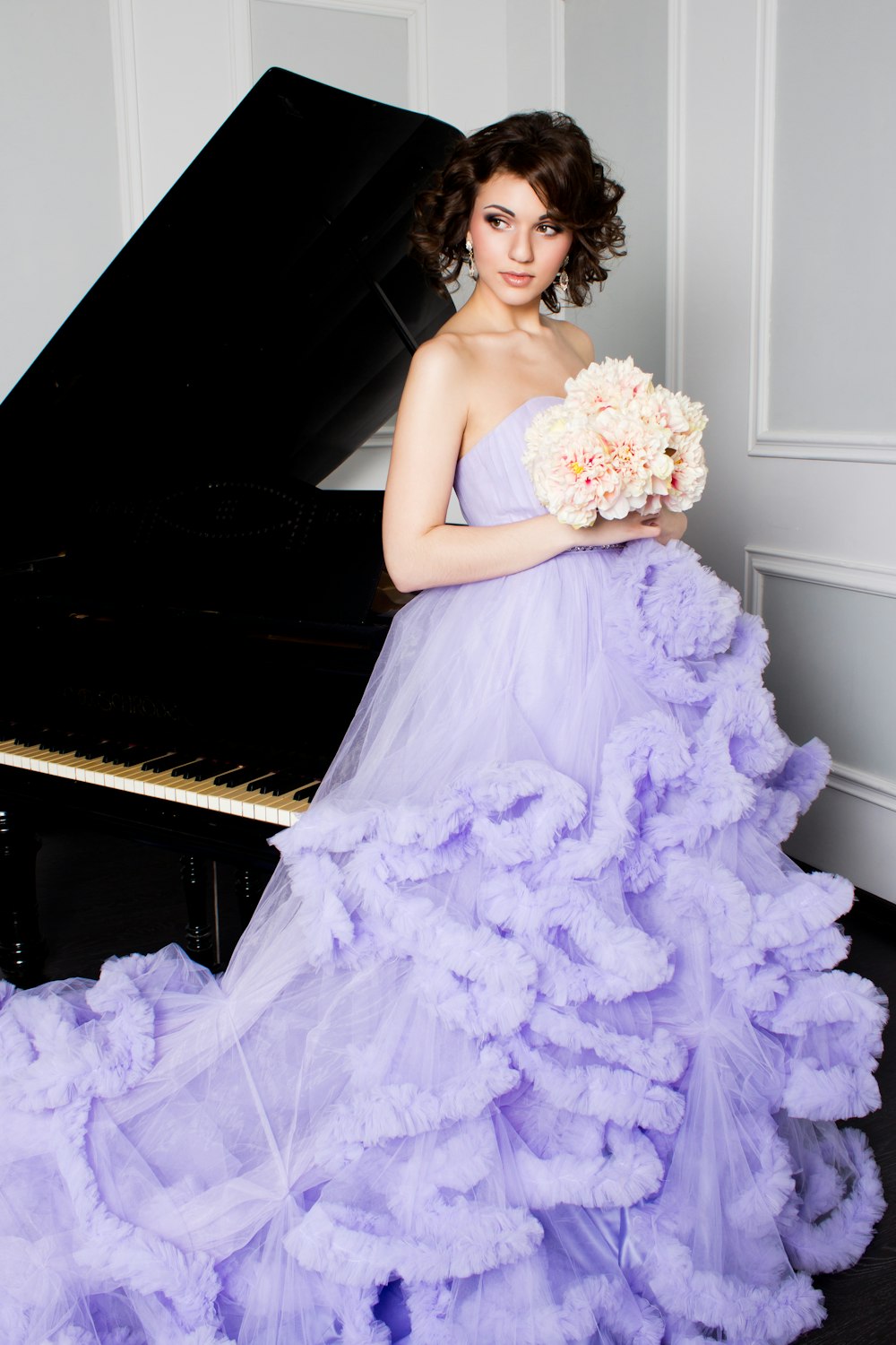 woman in purple off-shoulder dress holding bouquet of flowers