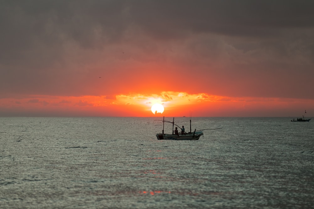 two people on boat during sunset