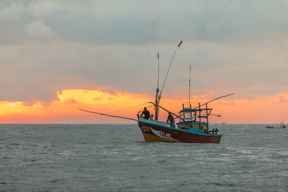 men riding on boat at middle of sea