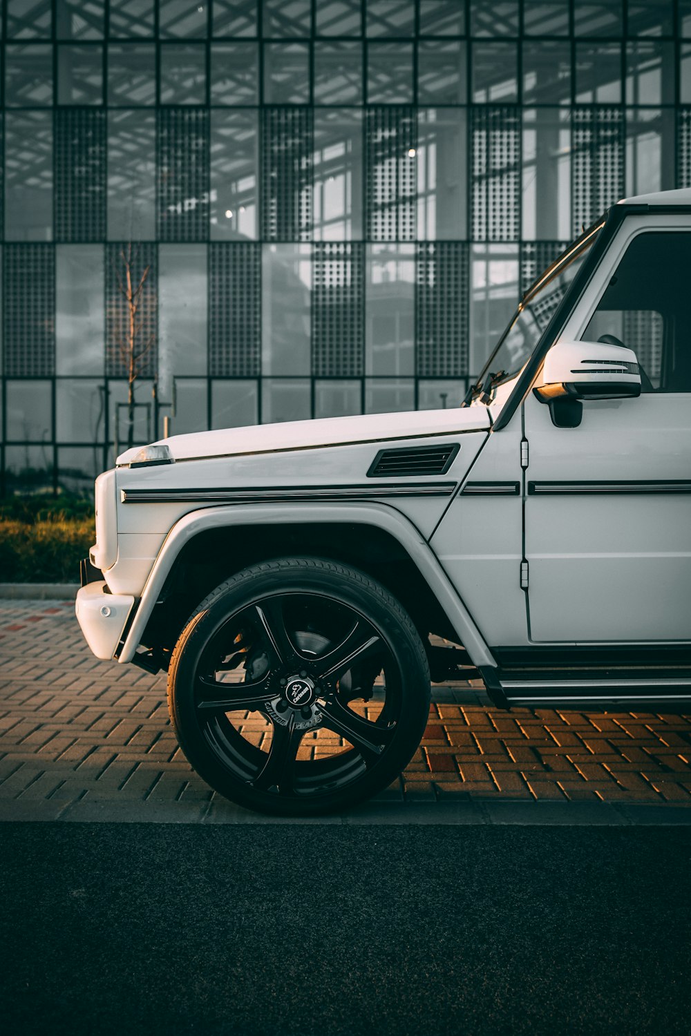 white vehicle parked outside building