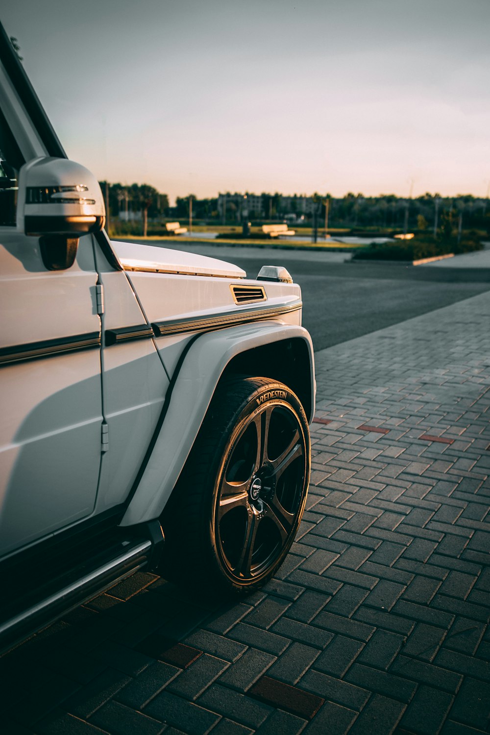 white car parked beside road