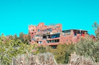 Historic mud-brick architecture of Asir region nestled among green hills.