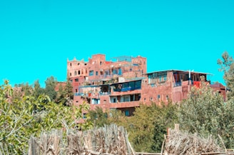 Historic mud-brick architecture of Asir region nestled among green hills.