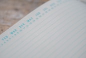 Close-up of a calendar with scheduled meetings.