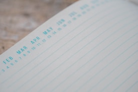 A close-up of a planner or calendar page featuring the months from February to October with a grid of lined rows beneath the month names.