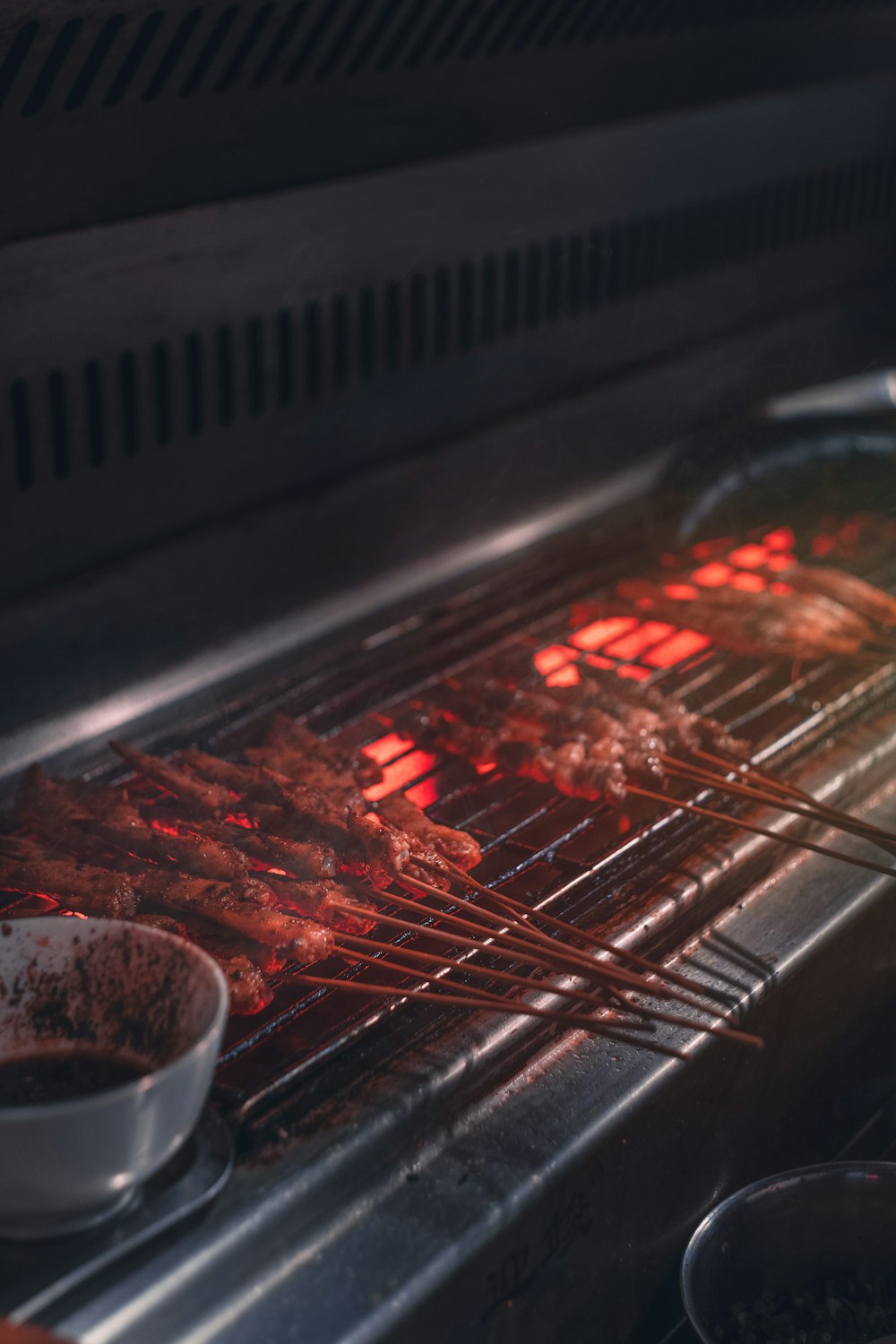 meat slices on sticks on barbecue grill