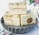 Several bars of handmade soap are neatly stacked on a scalloped metal dish. The soaps are individually wrapped in clear packaging and tied with rustic twine. A round label on one of the soaps reads 'Hand Crafted with Love For You.' The background features floral elements on a light surface.