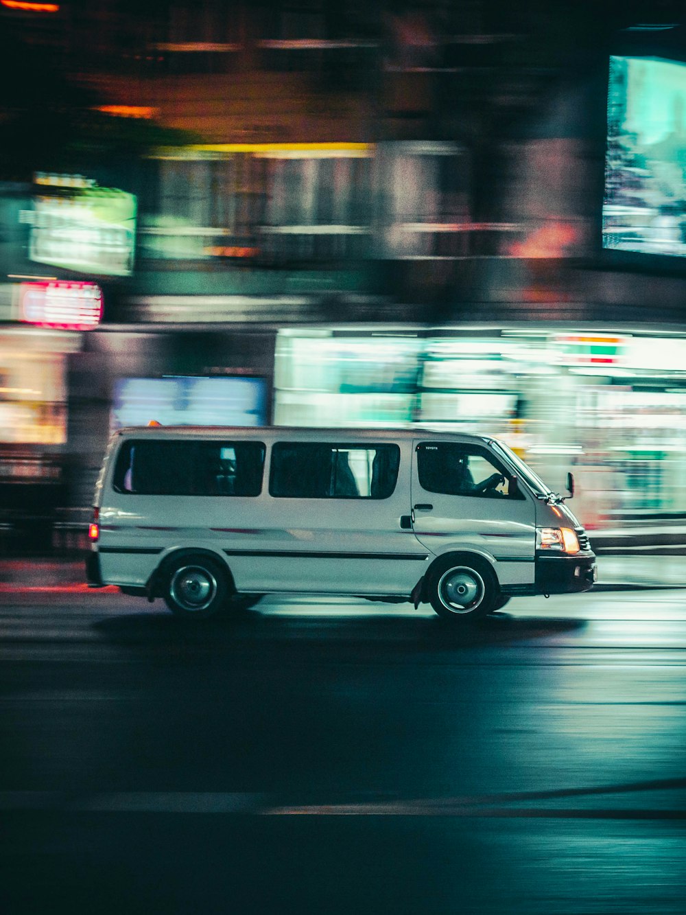 white van running on road