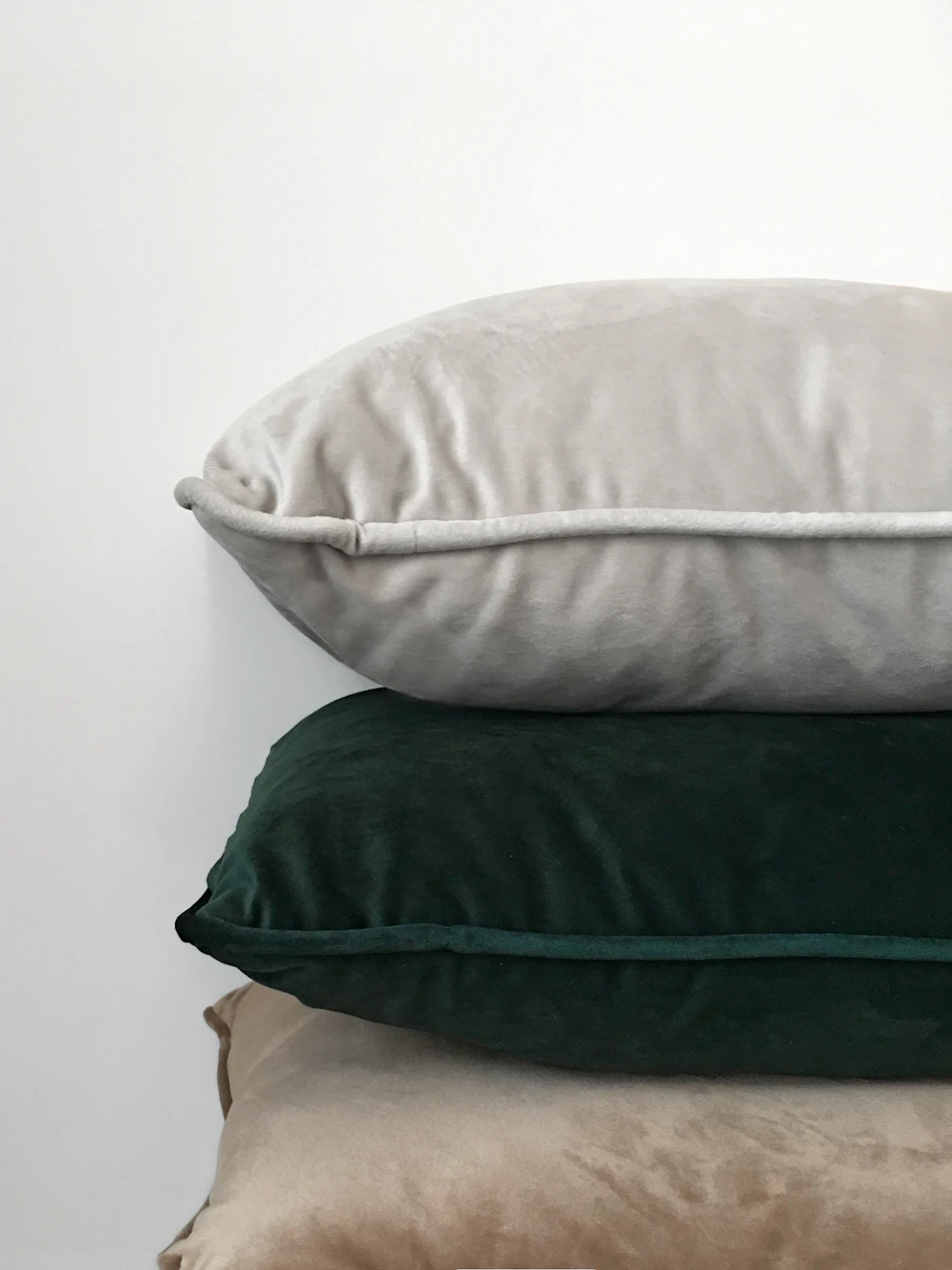 Three assorted colour cushions, showing fabric and pattern choices