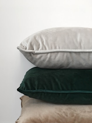 Three assorted-color pillows