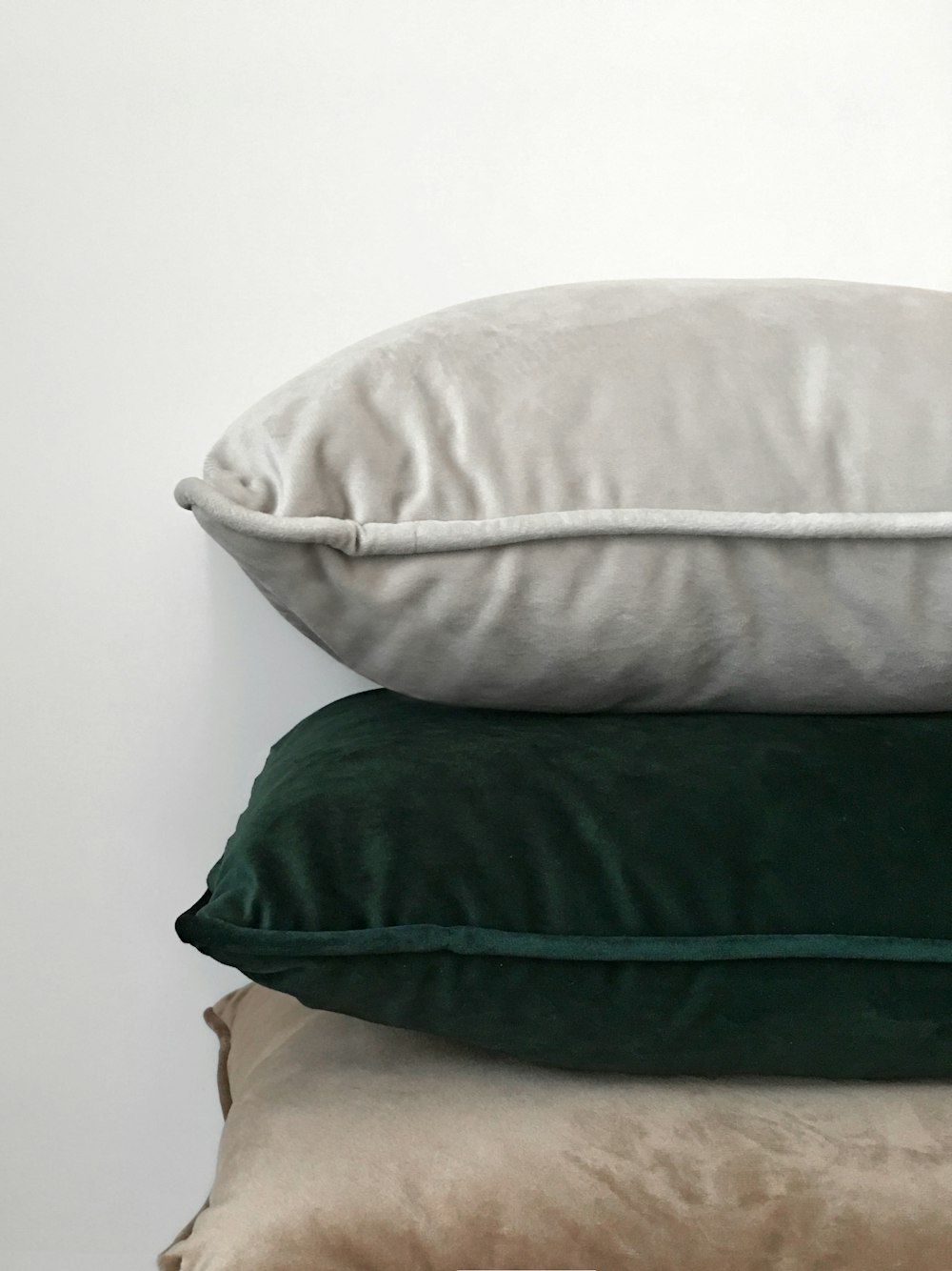three assorted-color pillows