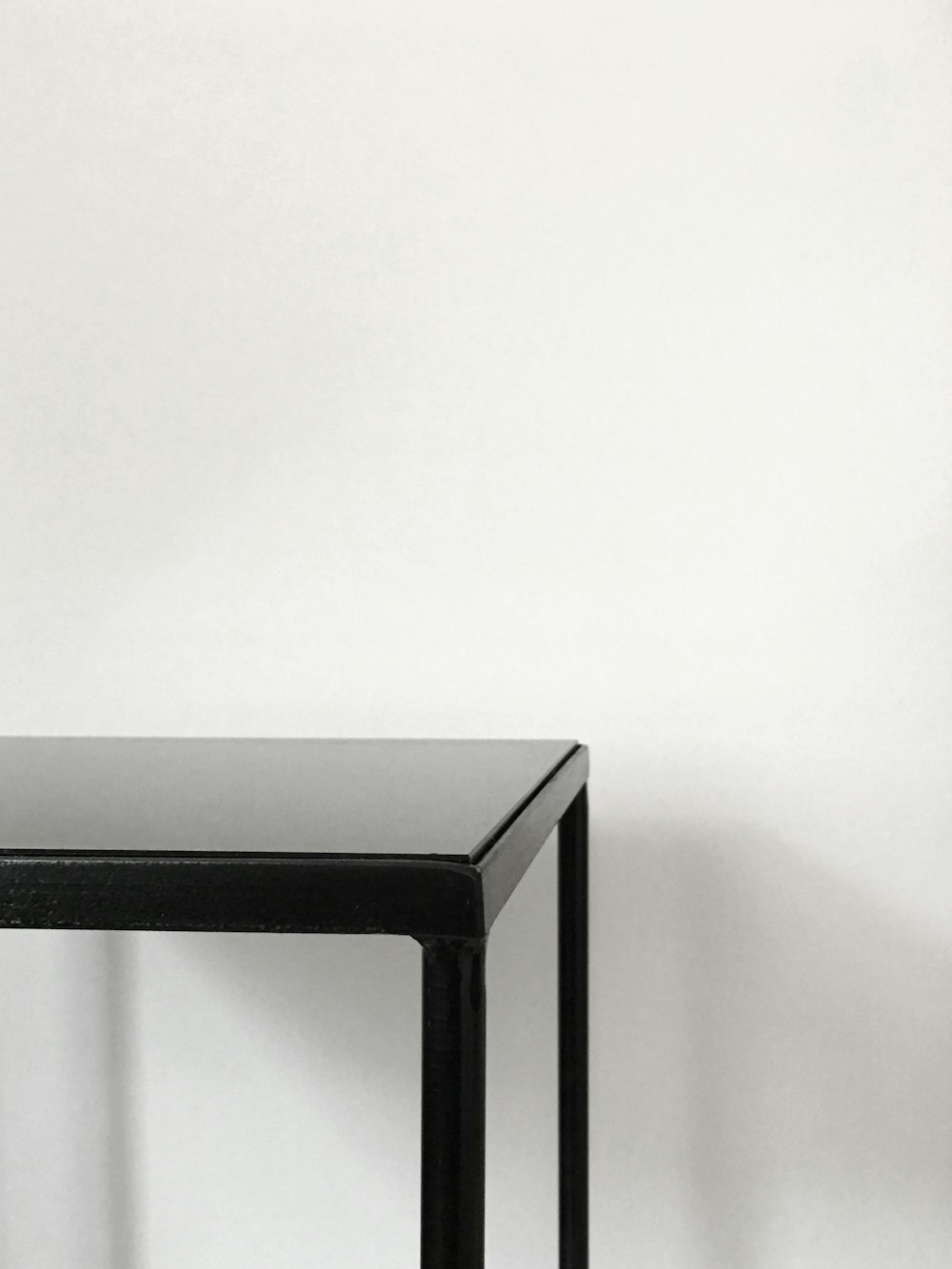 black metal table near white panted wall