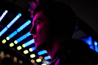 Portrait of Julio César, producer and musician, in colorful neon-lit studio