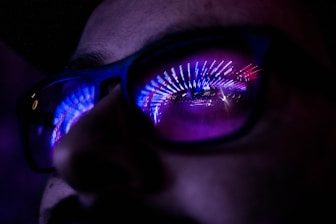 person wearing blue and maroon sunglasses