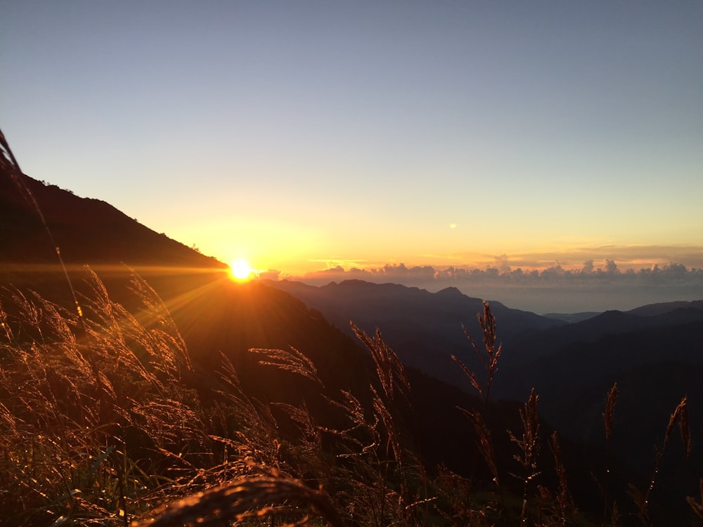 silhouette photo of mountains during golden hour