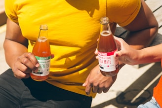 men holding two tea bottles