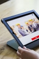 iPad with four business persons shaking hands display