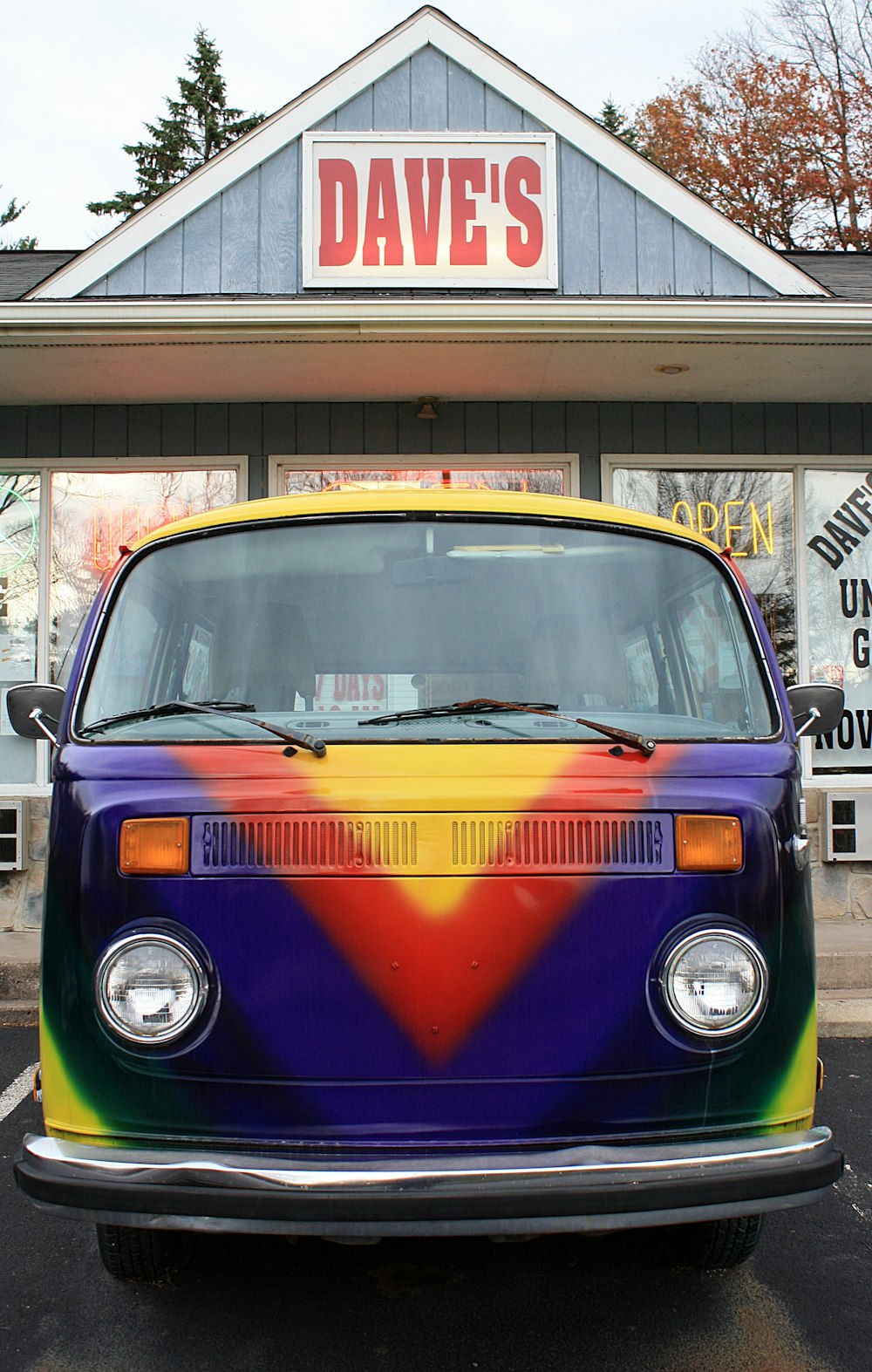 assorted-color van beside Dave''s store during daytime