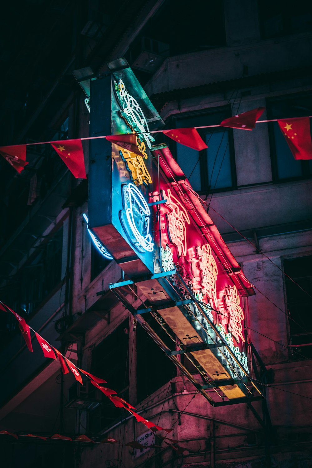 rectangular blue and red wooden stand during night time