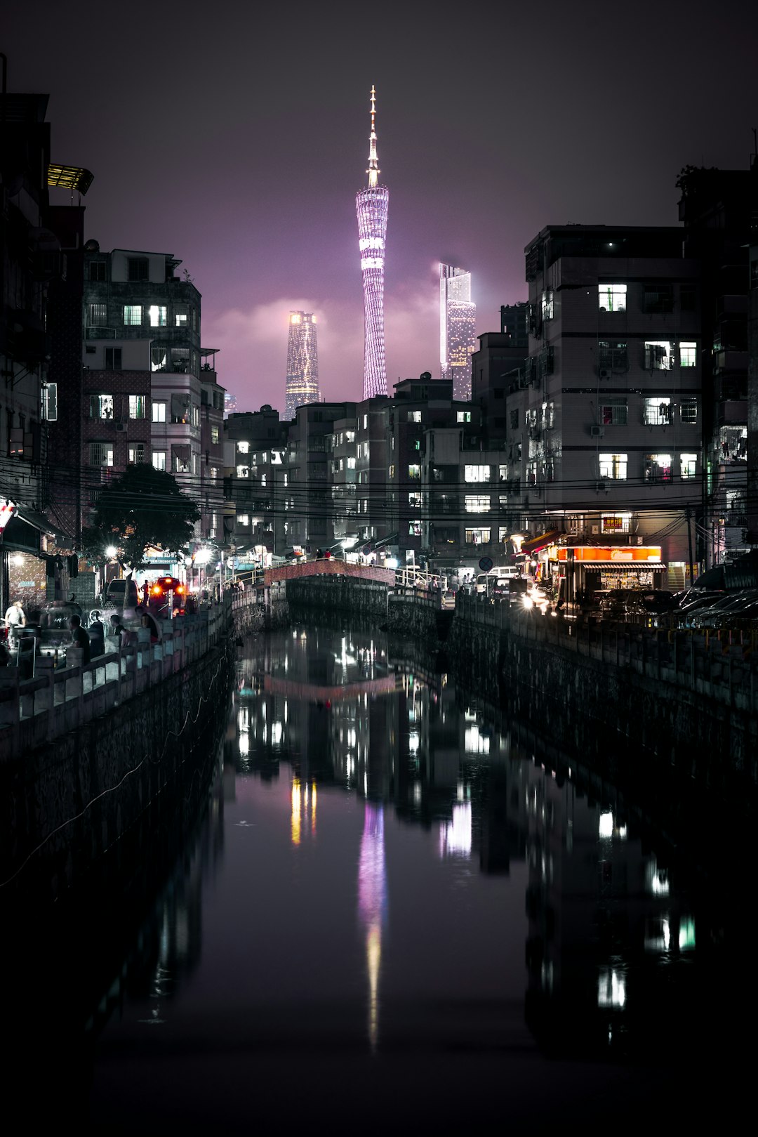 buildings reflected on water at night
