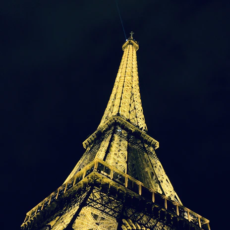 A vibrant photo of the Eiffel Tower glowing at sunset.
