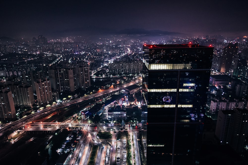 aerial photography of vehicles passing by streets of a city during nighttime