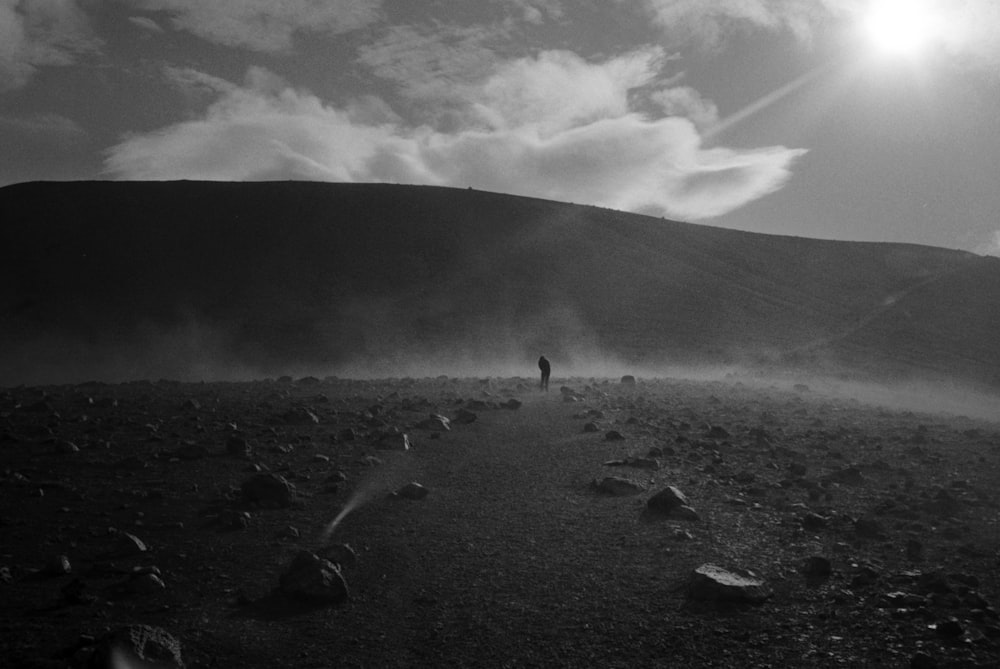 grayscale photography of man in an open field