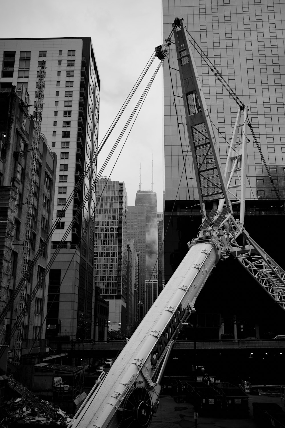 grayscale photography of crane in the city