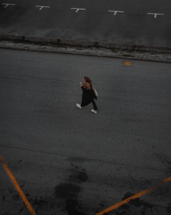 A person using a smartphone app to find available parking spots on a university campus.