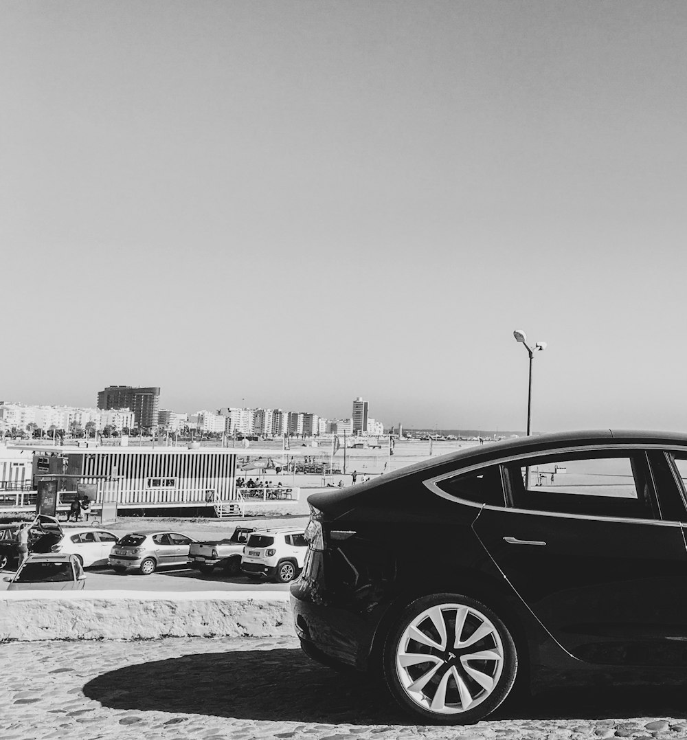 grayscale photography of car on road