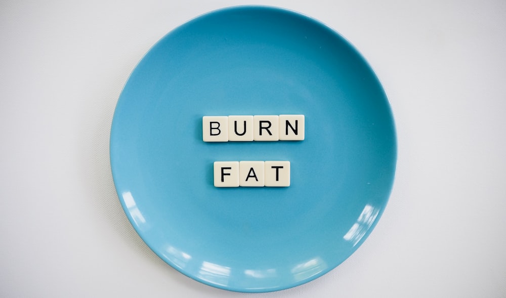 Burn Fat text blocks on round blue ceramic plate