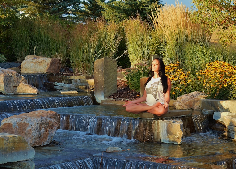 woman doing yoga on rock