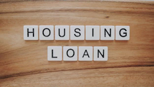 housing loan blocks on brown wooden surface