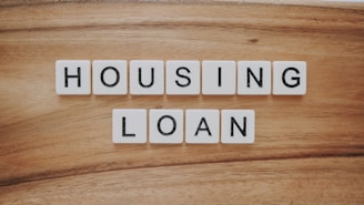 housing loan blocks on brown wooden surface