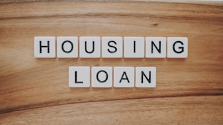 housing loan blocks on brown wooden surface