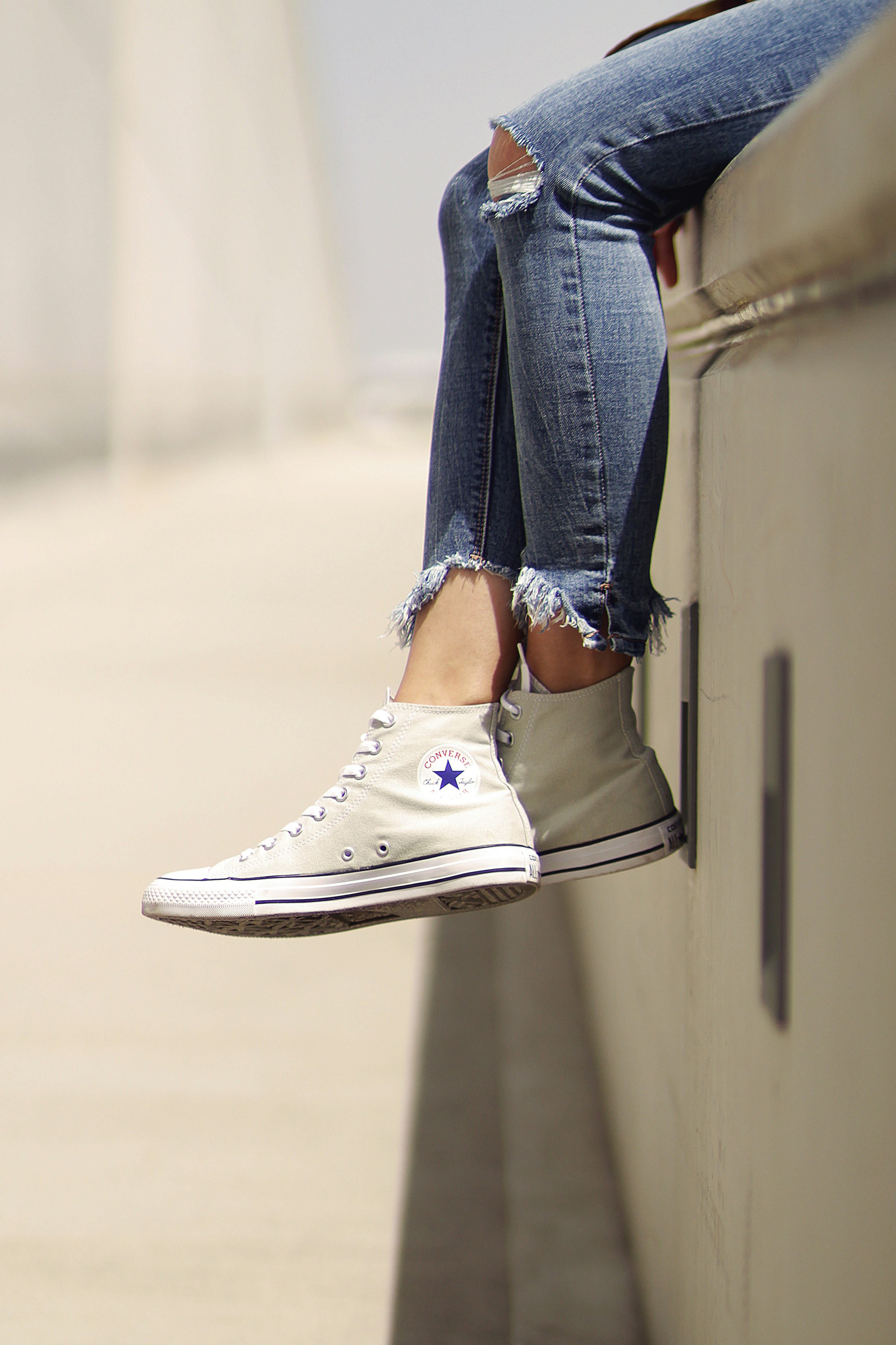 woman wearing white Converse low-top 