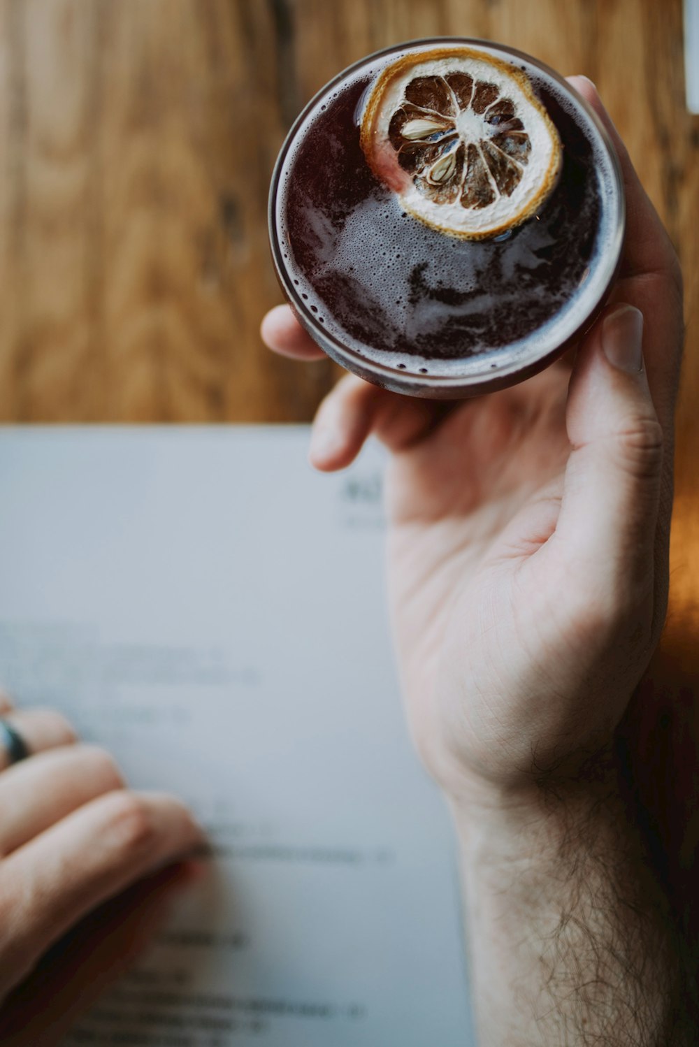 person holding cup of beverage