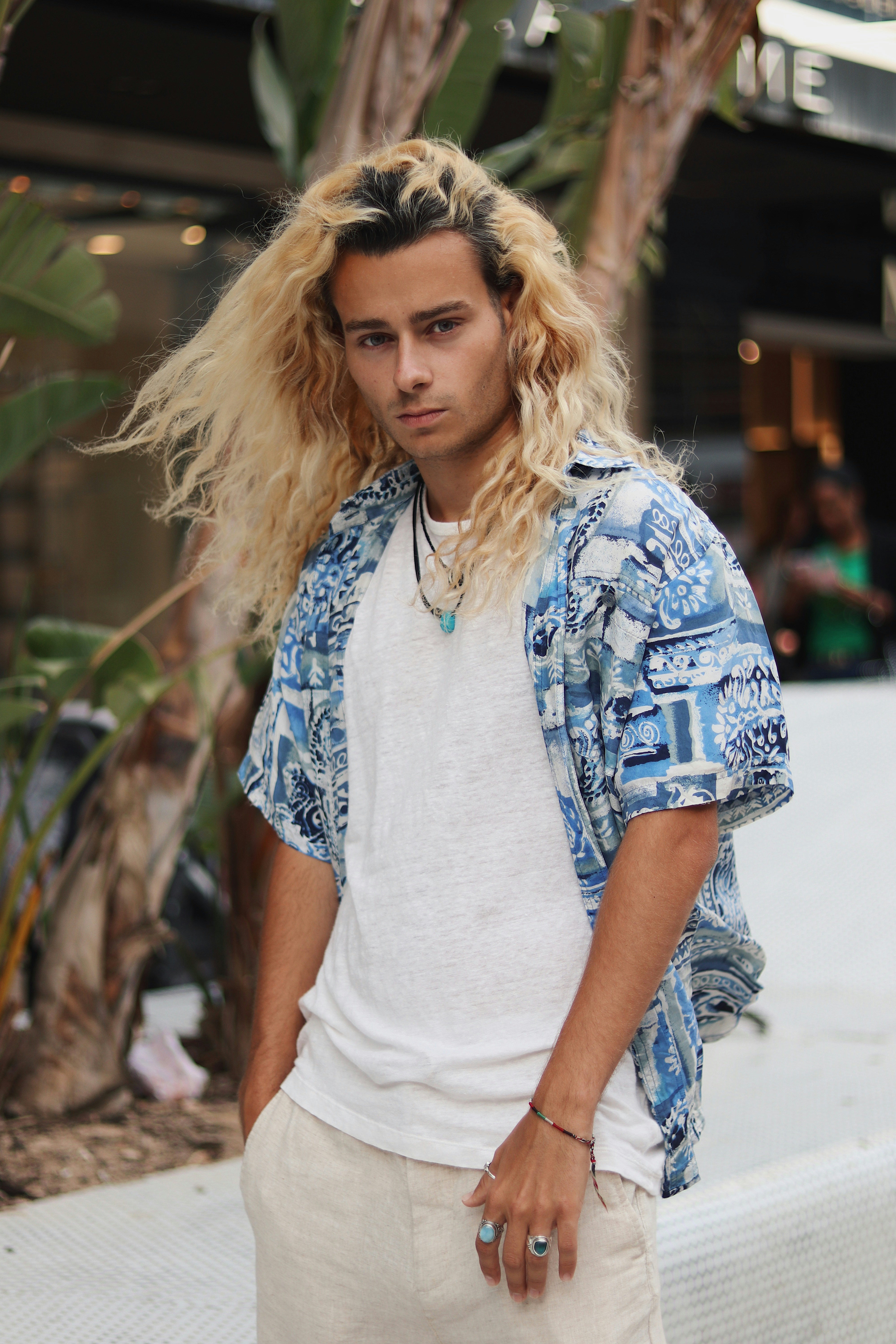 man in blue and white floral button-up shirt