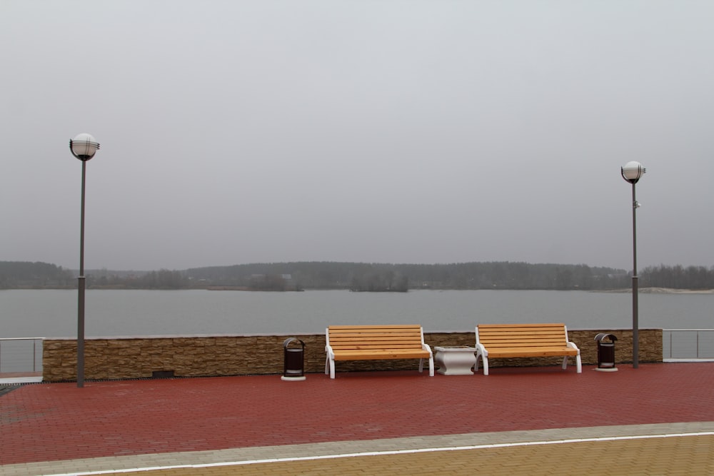 brown and white wooden bench beside water