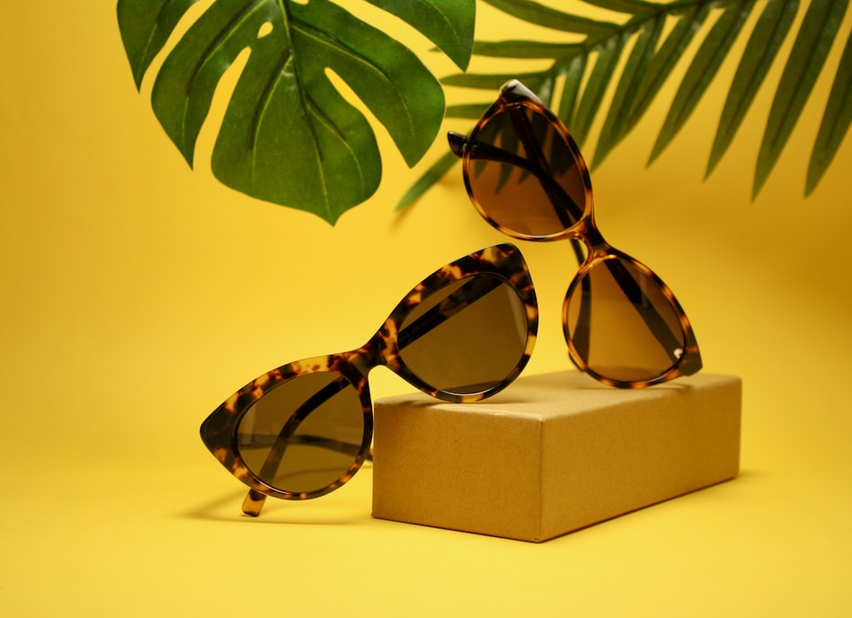 two tortoiseshell-framed Wayfarer-styled sunglasses with box