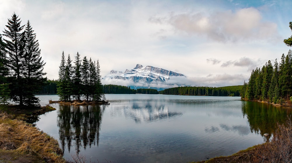 landscape photo of snow covered mountain near body of water during daytime