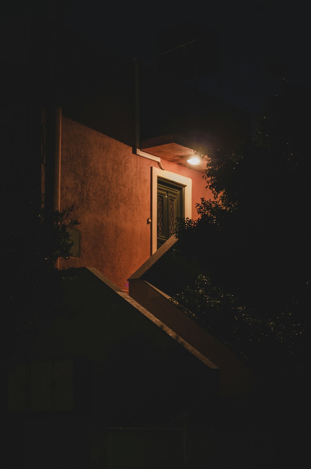 lighted brown house near tree