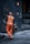 man in orange safety vest holding metal